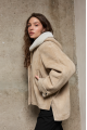 Stylish suede sheepskin coat made of natural sheepskin in beige color with a hood